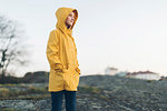 Girl wearing yellow coat in park