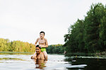 Son on his father´s shoulders in Lake Kappemalagol, Sweden