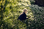 Girl picking flowers in meadow