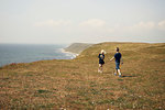 Boy and girl on hill near sea