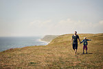 Man and boy on hill near sea