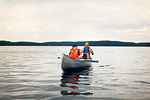 Father and son canoeing on lake