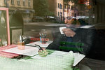 Young man with smart phone drinking coffee in cafe