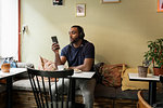 Young man listening to music in cafe