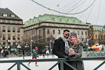 Couple using smart phone on ice rink