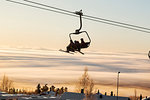 Silhouette of people on ski lift