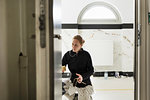 Painter working in apartment doorway