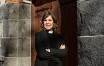 Portrait of priest outside church