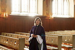 Portrait of priest in purple robes in church