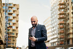 Man using smart phone in city