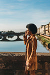 Young woman with afro hair crossing bridge, Florence, Toscana, Italy