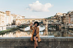 Young woman with afro hair taking selfie on bridge, Florence, Toscana, Italy