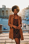 Young woman with afro hair leaning against handrail, Florence, Toscana, Italy