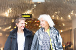 Mature woman and daughter leaving shop in city