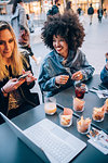 Friends having drinks at outdoor cafe, Milan, Italy