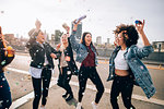 Friends celebrating with confetti and soap bubbles in street, Milan, Italy