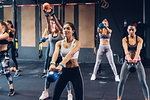 Women training in gym with kettle bells