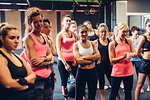 Group of women training in gym, listening