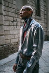 Stylish man standing by period building, Milan, Italy