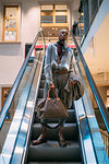 Stylish man descending on escalator, Milan, Italy