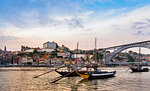 Traditional Portuguese wooden cargo boats transporting port wine on Douro River, Porto, Portugal