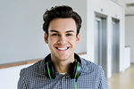 Businessman with headphones in office corridor