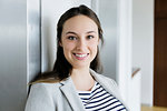 Businesswoman leaning against elevator door