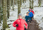Friends jogging in snowy woods