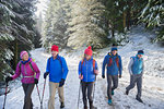 Family hiking in snowy woods