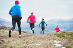 Friends jogging in mountains