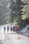 Family jogging in snowy woods