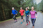 Family jogging in woods