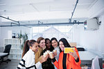 Businesswomen celebrating new office, taking selfie