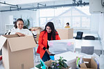Businesswomen unpacking, moving into new office