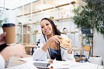 Businesswoman drinking coffee in meeting