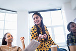 Happy businesswoman talking in conference room meeting