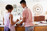 Mother and teenage son baking in kitchen