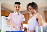 Mother and teenage son cooking in kitchen