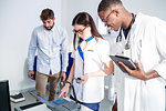 Doctors checking breathalyser machine in hospital