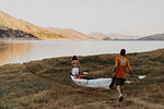 Couple carrying kayak to lake, Kaweah, California, United States