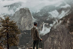 Hiker enjoying view of fog covering valley, Yosemite National Park, California, United States