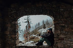 Hiker enjoying view of misty valley on ledge, Yosemite National Park, California, United States