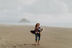 Mother and toddler playing with sand on beach, Morro Bay, California, United States