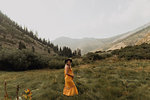 Pregnant mid adult woman in orange maxi dress in rural valley, portrait, Mineral King, California, USA