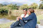 Couple relaxing by pond, Cape Town, South Africa