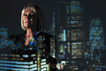 Double exposure thoughtful businesswoman against highrise lights at night