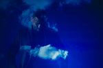 Double exposure businessman looking down against blue sky with clouds