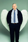 Portrait smiling businessman wearing angel wings