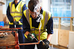 Male student working with copper in shop class workshop