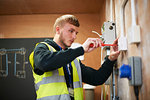 Male electrician student practicing in workshop